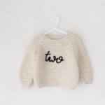 Two jumper part of the studio wardrobe for when toddlers turn two on their birthday photoshoot.