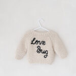 Knitted Love Bug jumper in my newborn photography studio in Cheshire.