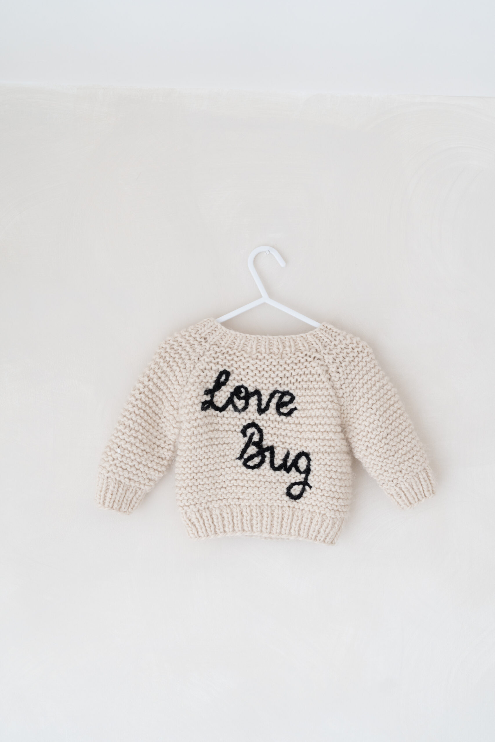 Knitted Love Bug jumper in my newborn photography studio in Cheshire.