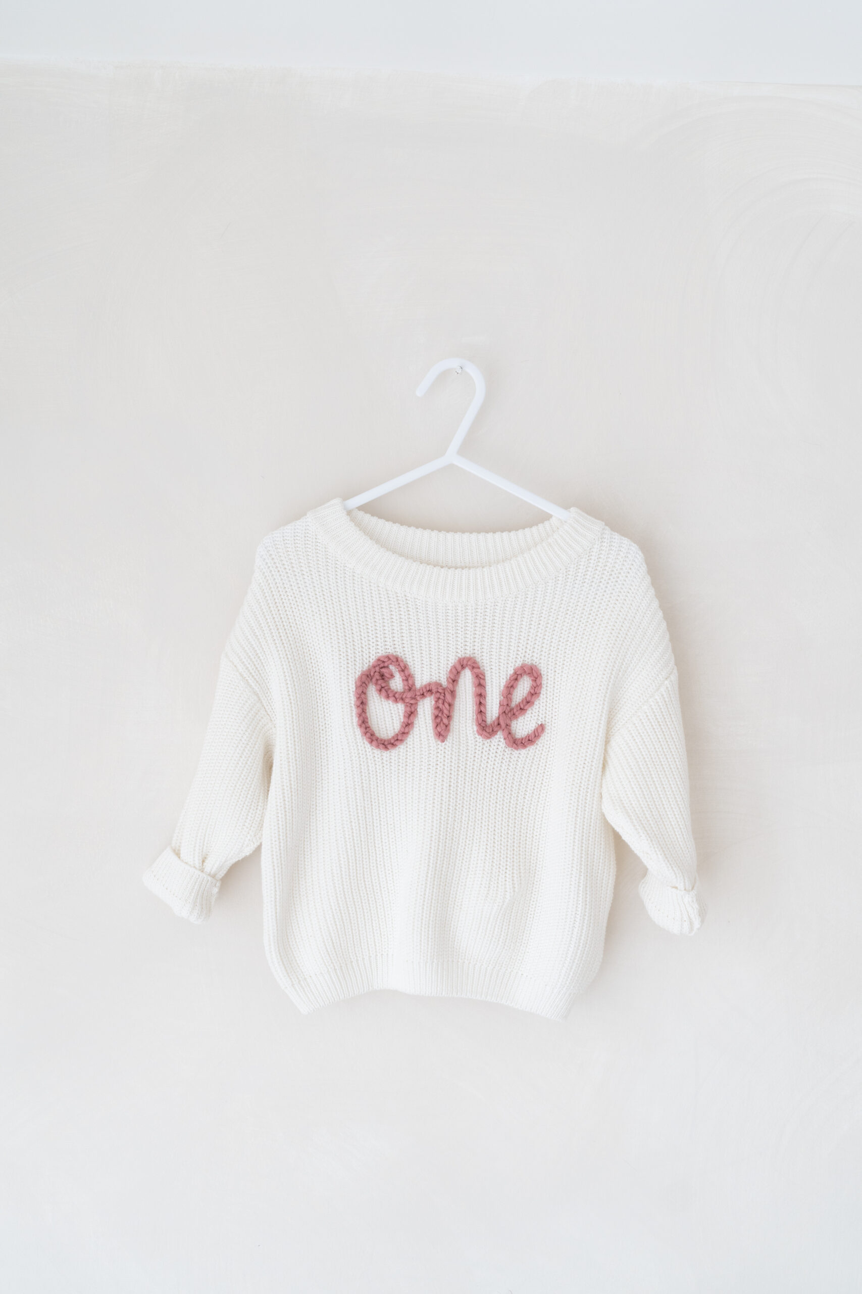 Over-sized one jumper part of the studio wardrobe for first birthday photoshoots.