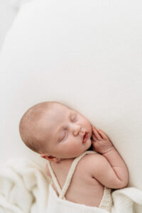 Newborn girl asleep on her photoshoot near Wilmslow