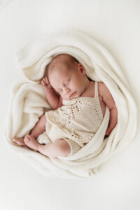 beautiful baby girl asleep on a natural newborn photoshoot in Wilmslow