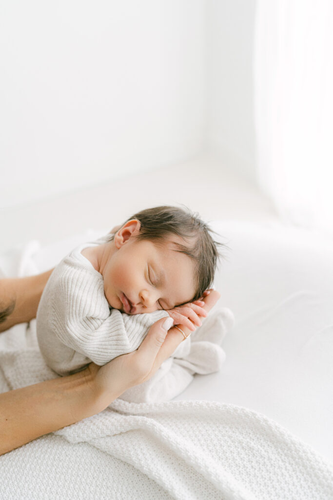 Gorgeous newborn girl sleeping on her newborn photoshoot.