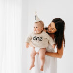 Baby boy and mother on cake smash photoshoot in Cheshire