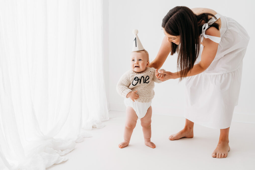 Baby boy and mother on cake smash photoshoot in Wilmslow