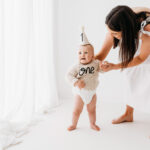 Baby boy and mother on cake smash photoshoot in Wilmslow