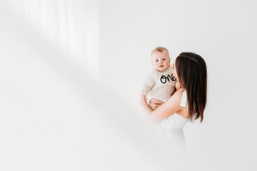 Baby boy and mother on cake smash photoshoot in Macclesfield