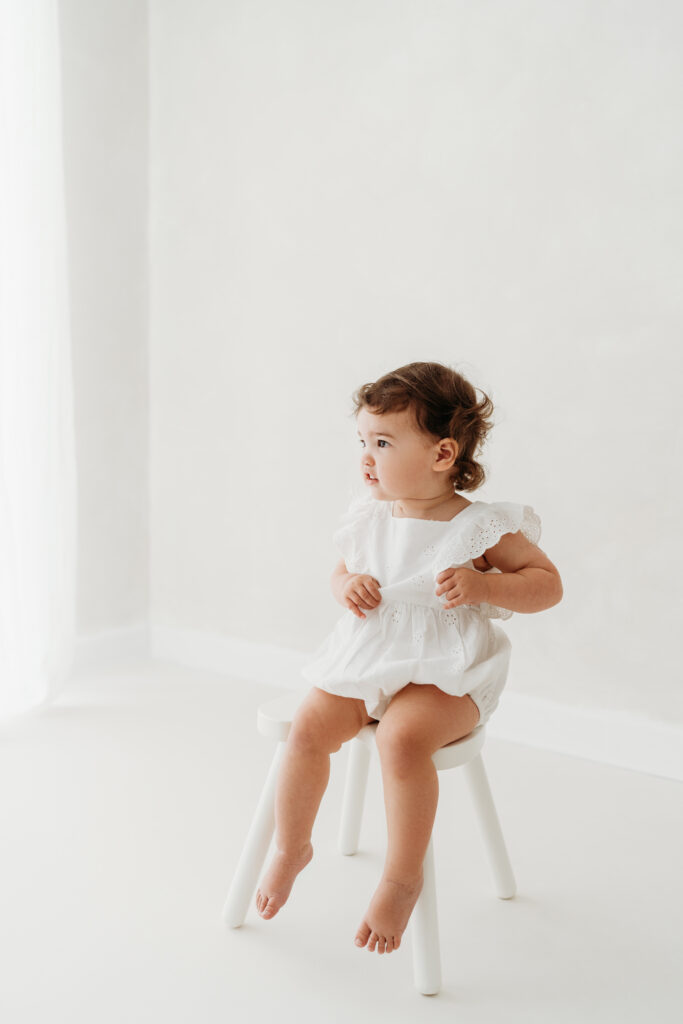 Young girl sitting on her toddler photoshoot in Cheshire