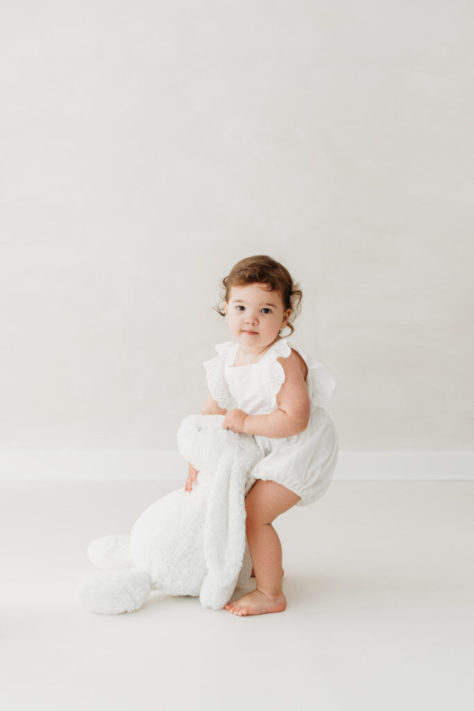 Little girl holding her teddy on her toddler photoshoot in Cheshire