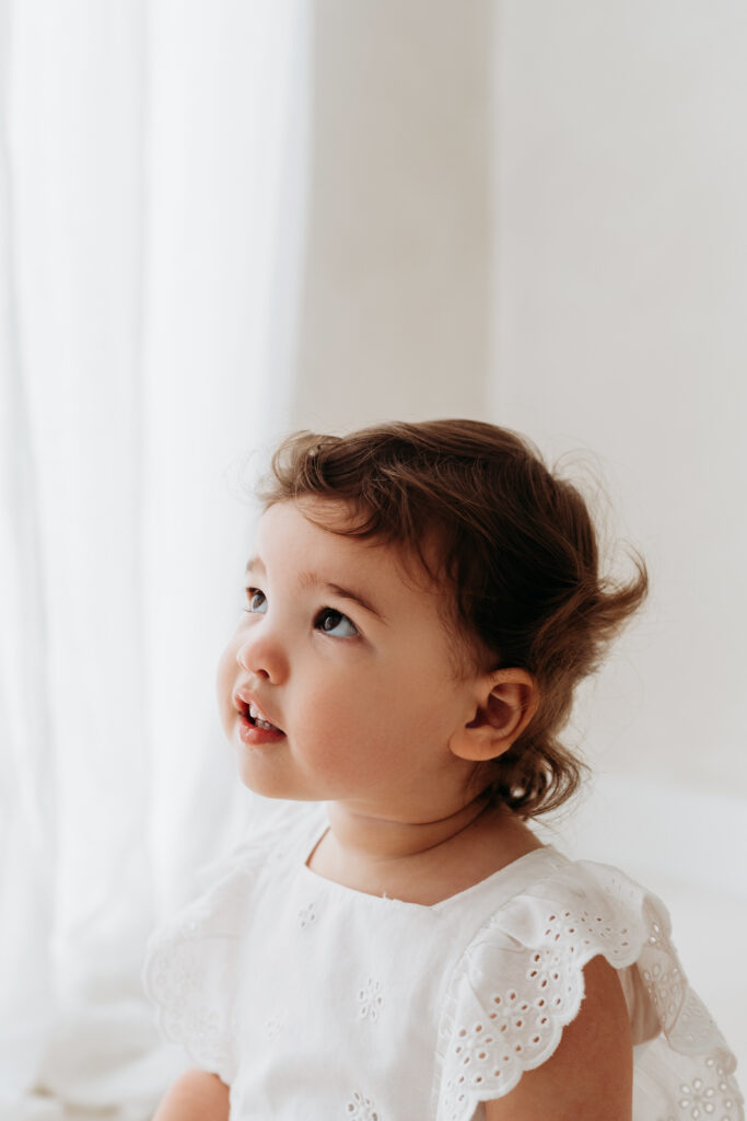 Young toddler looking up to her mother on her natural toddler photoshoot in Cheshire