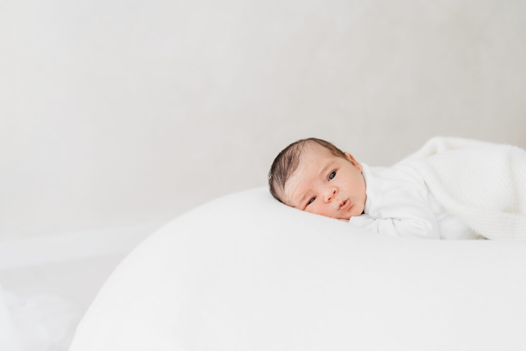 Newborn baby lying on a beanbag on a natural newborn photoshoot in Cheshire