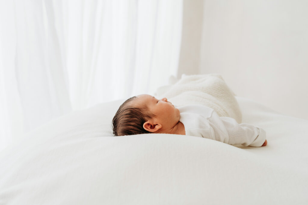 Sleeping baby boy on a bean bag on a natural newborn photoshoot in Cheshire